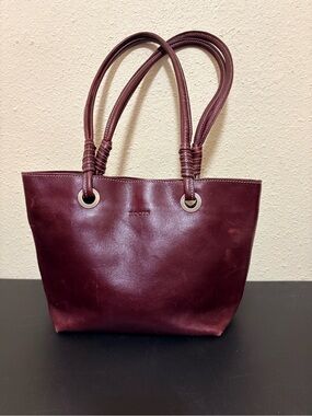 Roots burgundy leather tote bag with double shoulder straps.